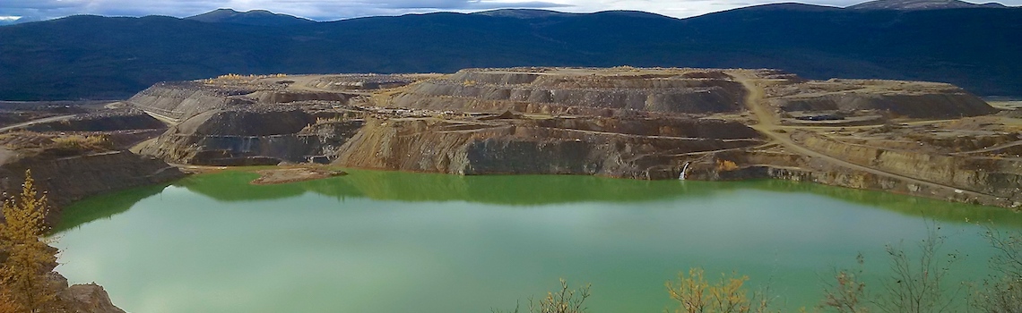 Open pit and waste-rock piles at the Faro Mine, Yukon